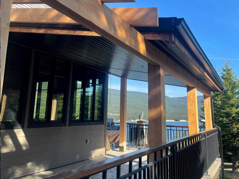 Wooden terrace with railing overlooking a scenic lake