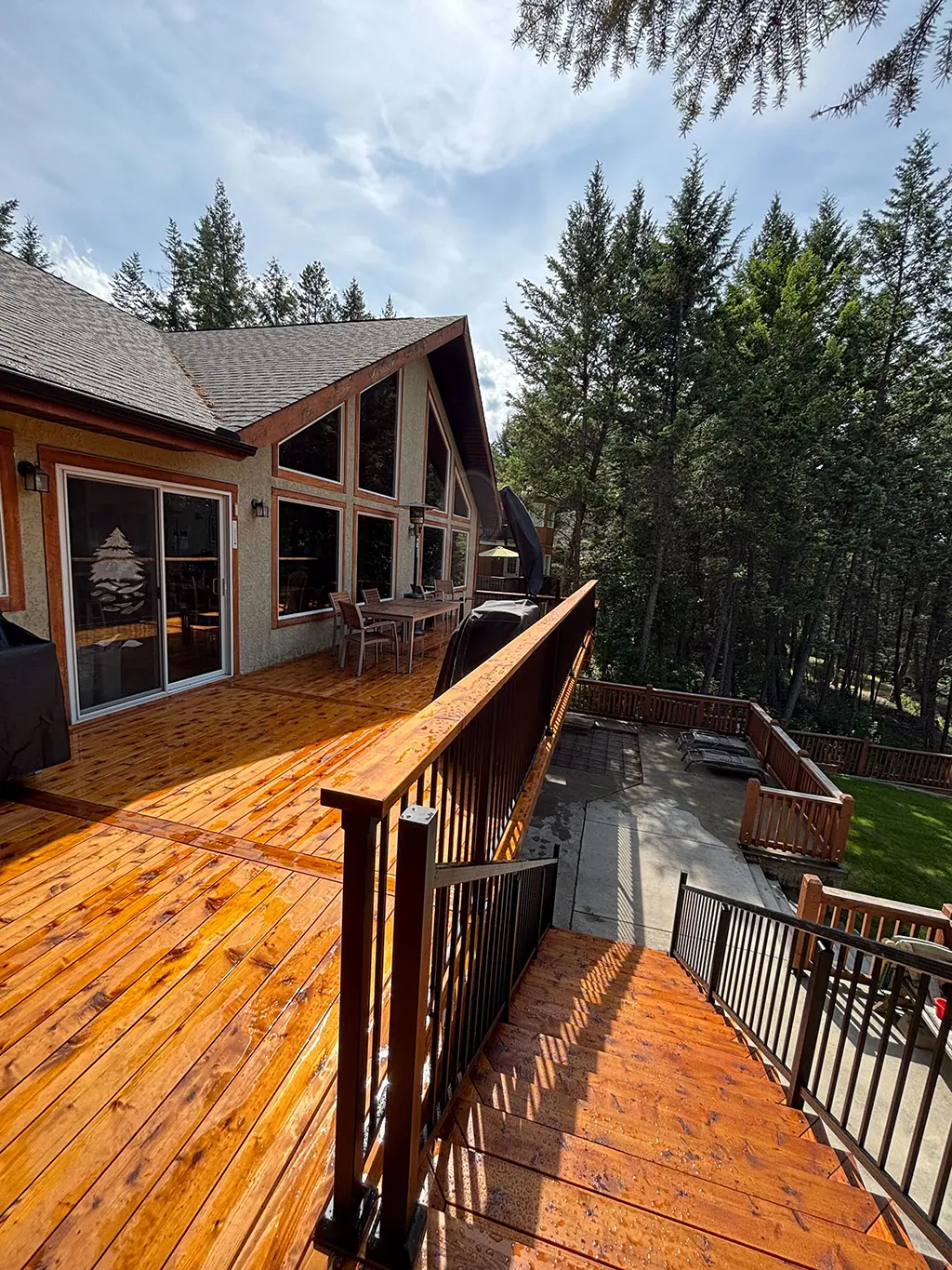 wood deck with stairs and iron bar railing