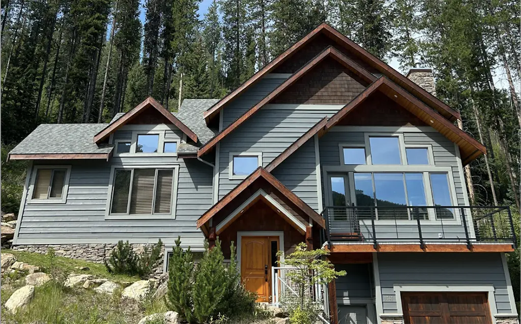 house built into the side of a hill with custom windows