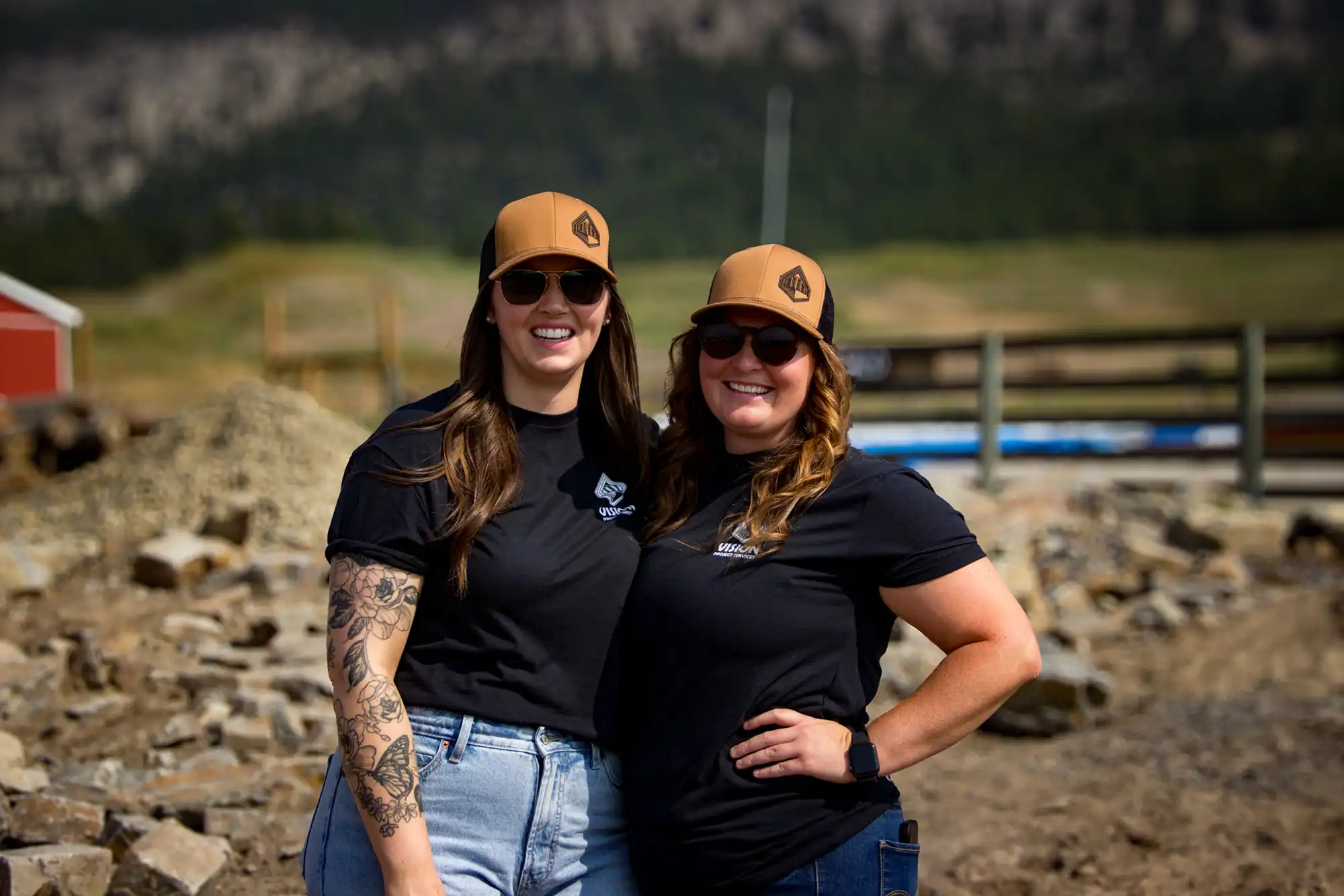 owners of Vision Project Services embracing in front of a new construction plot
